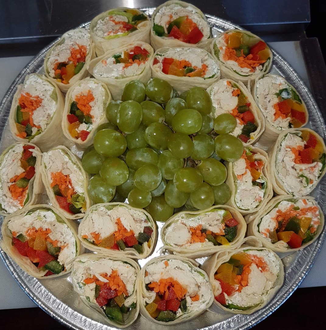Party size tray of Florcita's Antojitos with grapes in centre of plate.