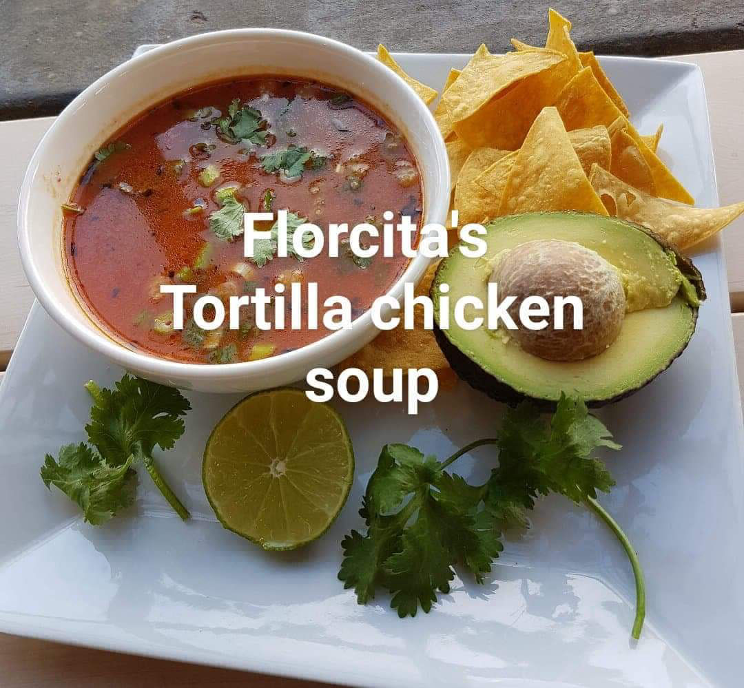 Florcita's Tortilla chicken soup with avacado, parsley and lime garnishes.