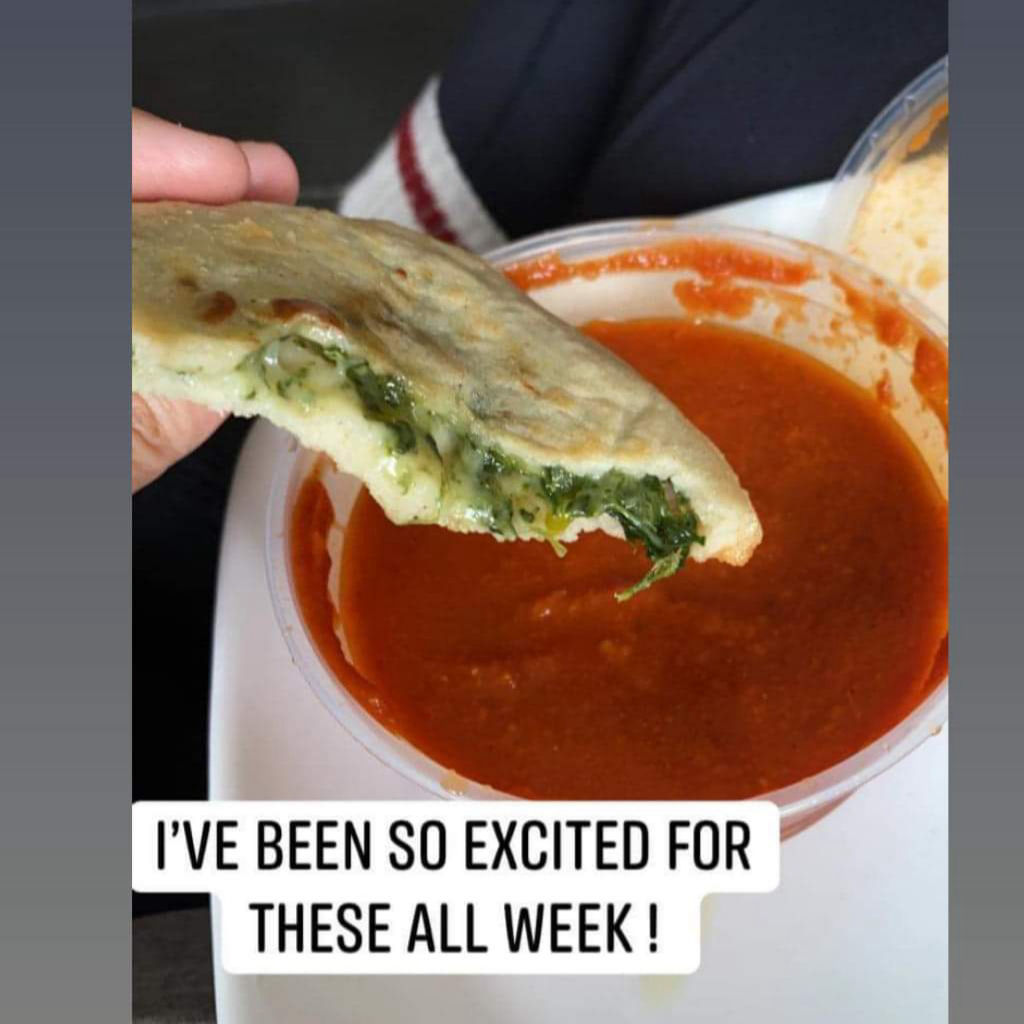 Spinach and Cheese papusa with dip and statement saying 