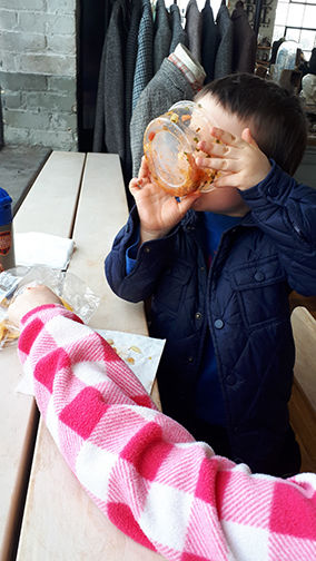 Little boy tipping salsa bowl directly into his mouth... bottoms up!
