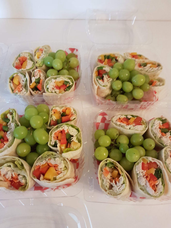 Four dishes of personal size Antojito servings with green grapes.